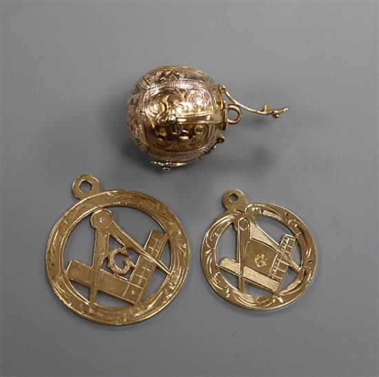 A 9ct and white metal masonic ball pendant and two 9ct gold masonic pendants.